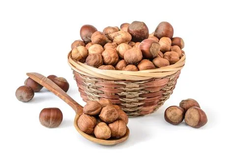 Hazelnuts and kernels in a basket on a white background with soft shadow Stock Photos