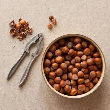 Hazelnuts and nutcracker Stock Photos