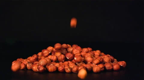 A hazelnuts are falling on a pile of nuts Vídeo Stock 58669221