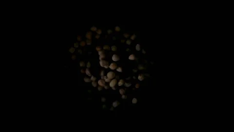 Hazelnuts are flying on a black background Video stock 112832929