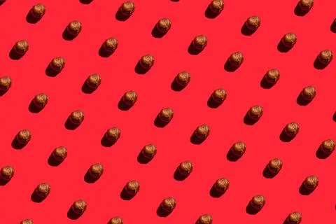 Hazelnuts background. A trendy sunlight pattern made of hazelnuts against a b Stock Photos