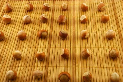 Hazelnuts on a bamboo mat Stock Photos