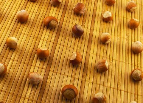 Hazelnuts on a bamboo mat Stock Photos