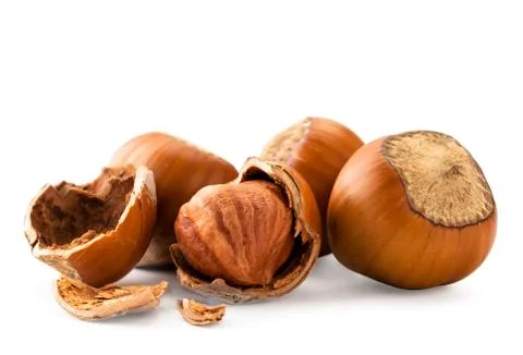 Hazelnuts with broken shells close - up on a white. Isolated Stock Photos