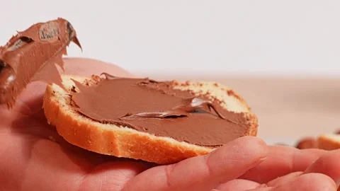 Hazelnuts chocolate spread on bread Stock Footage 272475765
