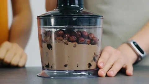 Hazelnuts, cocoa powder are being ground inside a blender. Delicious homemade Video stock 132501189