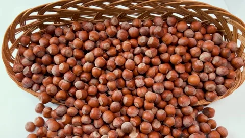 Hazelnuts come out of  wicker basket Stock Footage 274028183