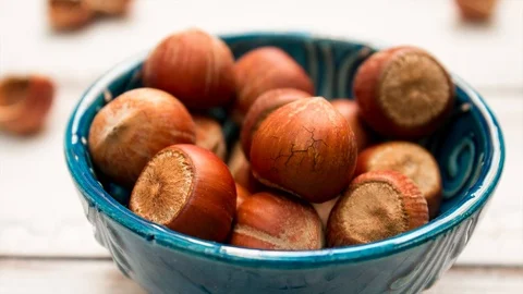 Hazelnuts crack in a blue plate Stock Footage 118052882