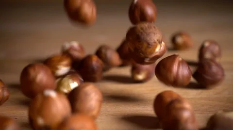 Hazelnuts drop and bounce on table, slow motion Stock Footage 61297054