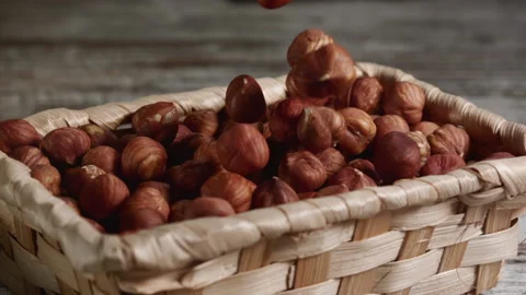Hazelnuts falling into a basket Stock Footage 152383361