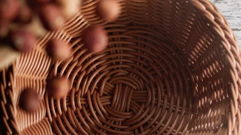 Hazelnuts falling into a basket Stock Footage 152384177