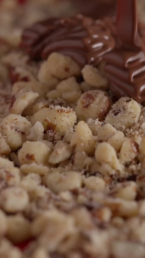 Hazelnuts falling, chocolate pouring over, slo-mo Stock Footage 332084542