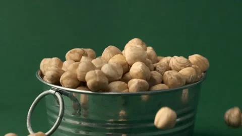 Hazelnuts falling down in the pile in a slow motion Stock Footage 229324767