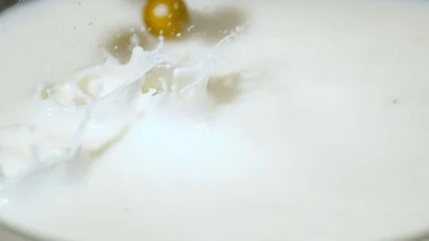 Hazelnuts falling into milk, Ultra Slow Motion Stock Footage 86578065