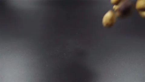 Hazelnuts falling in slow motion on black background Stock-Footage 104576125