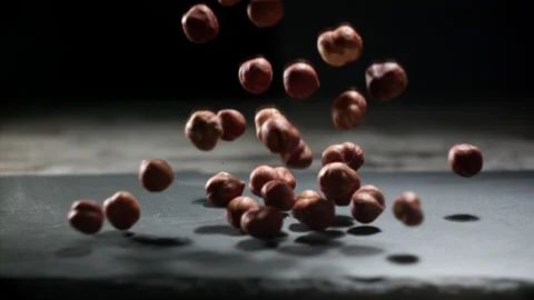 Hazelnuts falling on a table Stock Footage 152383650