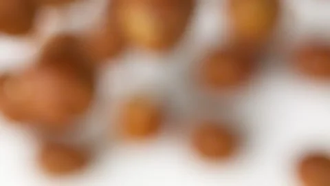 Hazelnuts flies on the white background slow motion close up Video stock 148553567