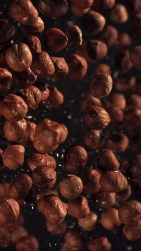Hazelnuts fly up and fall down. Filmed on a high-speed camera at 1000 fps Stock Footage 335372985