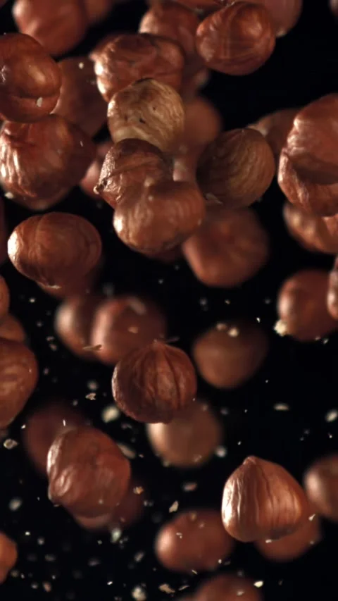Hazelnuts fly up and fall down. Filmed on a high-speed camera at 1000 fps Stock Footage 335376530