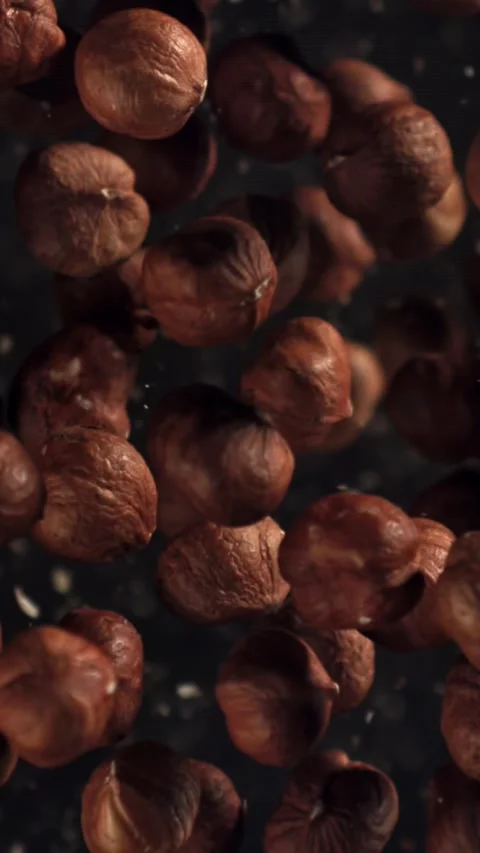 Hazelnuts fly up and fall down. Filmed on a high-speed camera at 1000 fps Stock Footage 335380072