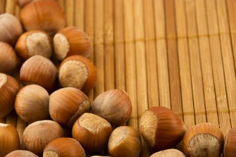 Hazelnuts isolated on a bamboo mat Stock Photos