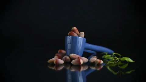 Hazelnuts with nutcracker isolated on black background. Stock Footage 297264724