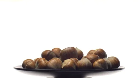 Hazelnuts in nutshell. Rotation. Closeup. Selective focus. Isolated on white. Video stock 101556048