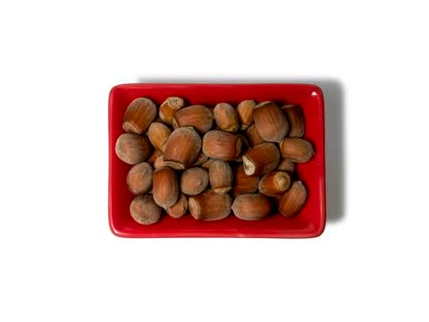 Hazelnuts in a red rectangular saucer isolated on white background. View from Stock Photos