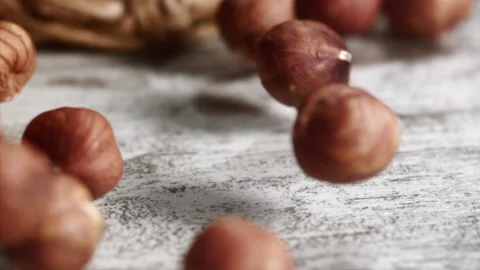 Hazelnuts rolling on a table Stock Footage 152383814