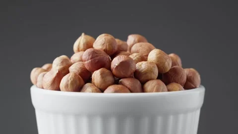 Hazelnuts rotating in white bowl on background. Pile of healthy food for vegan. Stock Footage 294926506