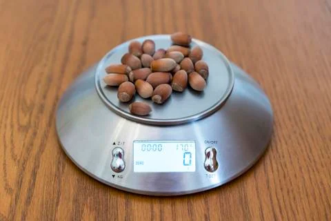 Hazelnuts on the scales Stock Photos