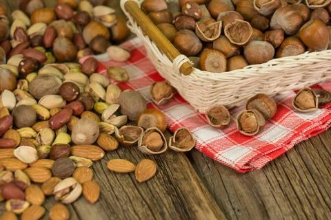 Hazelnuts in small wicker basket, nut mix, selective focus Stock Photos