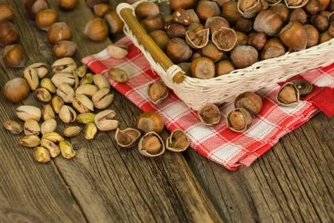 Hazelnuts in small wicker basket, nut mix, selective focus 스톡 사진