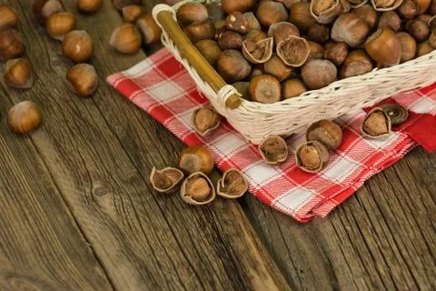 Hazelnuts in small wicker basket Stock Photos