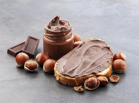 Hazelnuts splash with chocolate paste Stock Photos