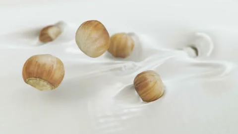 Hazelnuts Splashing Into Liquid Cream in 4K Super slow motion Stock Footage 139142913