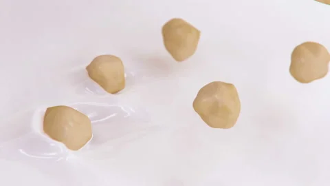 Hazelnuts Splashing Into Liquid Cream in 4K Super slow motion Stock-Footage 141675276