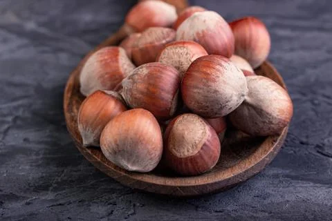 Hazelnuts in a spoon on a dark background Stock Photos