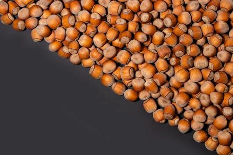 Hazelnuts. Stack of hazelnuts. Food background. Hazelnut on darck background Stockfoto's