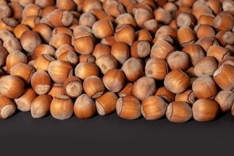 Hazelnuts. Stack of hazelnuts. Food background. Hazelnut on darck background Stockfoto's
