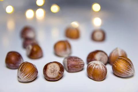 Hazelnuts on a white background with blurred lights in the background Stock Photos