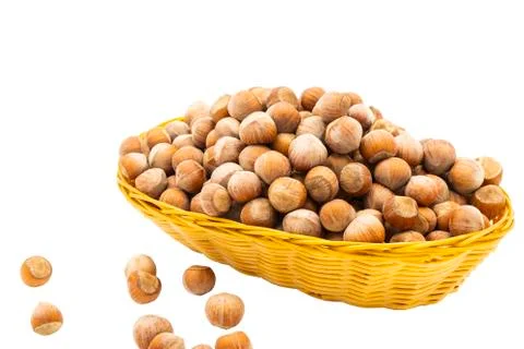 Hazelnuts in a wicker basket. Isolate on white background. Stock Photos