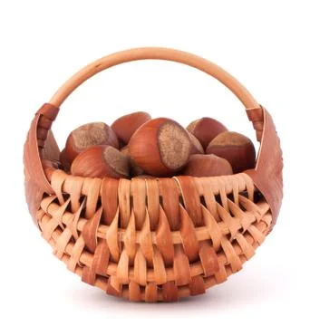 Hazelnuts in wicker basket Stock Photos