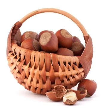 Hazelnuts in wicker basket Stock Photos