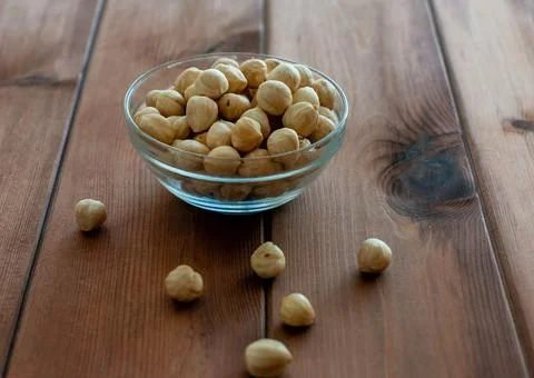 Hazelnuts without shell on a wooden background Stock Photos