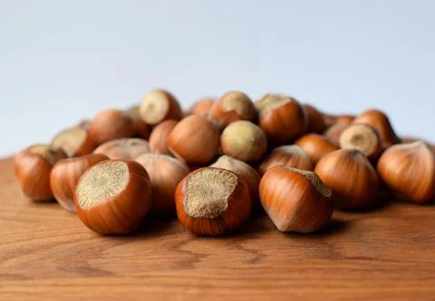Hazelnuts on a wooden background. Hazelnuts in shell, healthy food Stock Photos