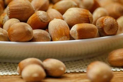 Hazelnuts on wooden table Stock Photos