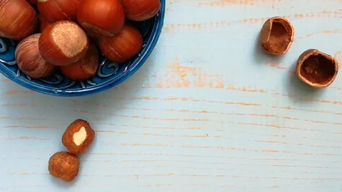 Hazelnuts on a wooden table the shell moves Stock Footage 117543585