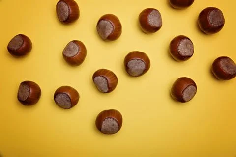 Hazelnuts on a yellow background. Stock Photos