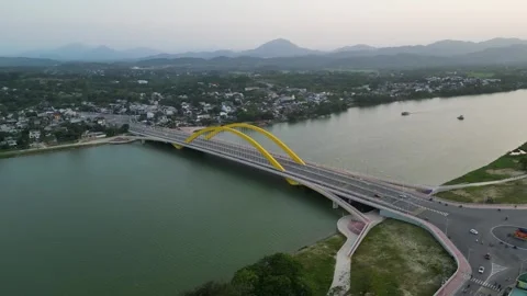 Hazy flat light aerial circles Cau Nguyen Hoang Bridge in Hue, Vietnam Vidéo 336472560